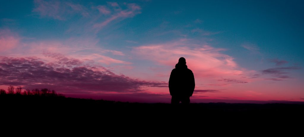 a man looking at the evening sky