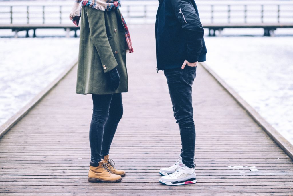 a couple standing together facing each other and their heads out of picture