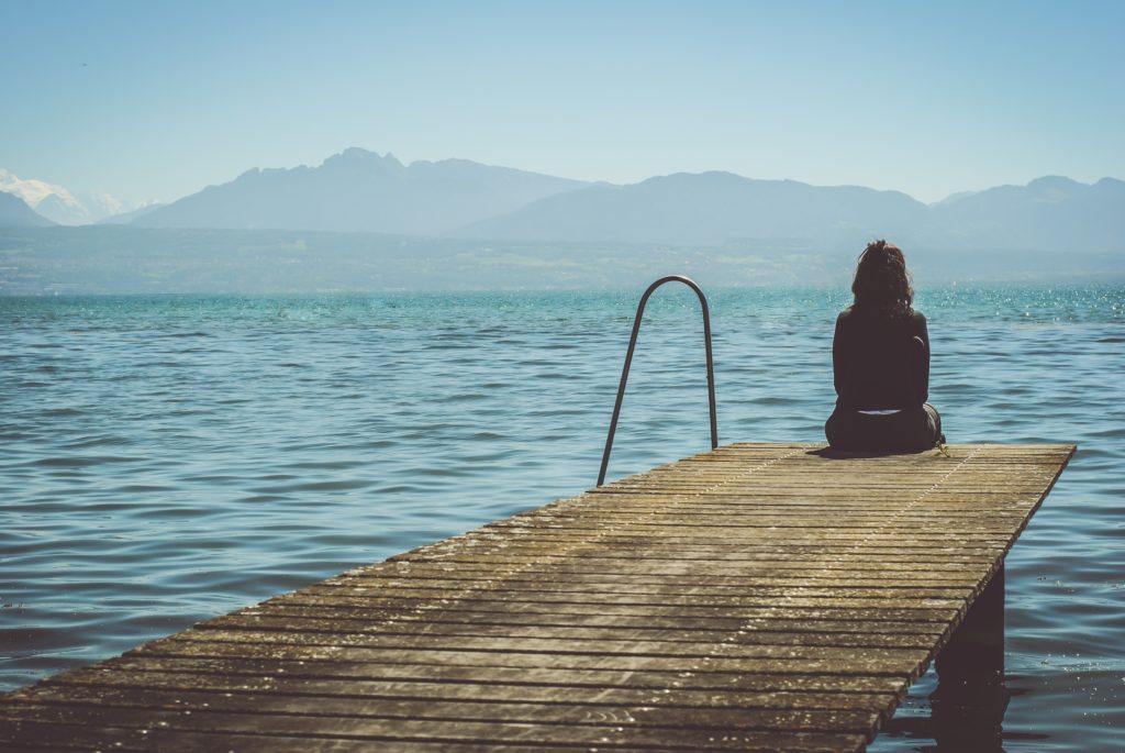 Lonely girl sitting alone